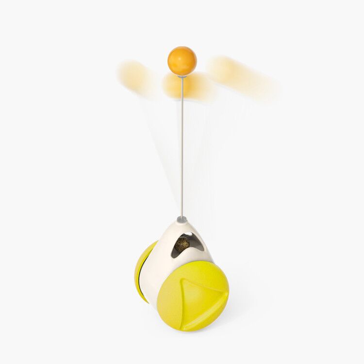 Toy with a yellow ball on a string against a white background