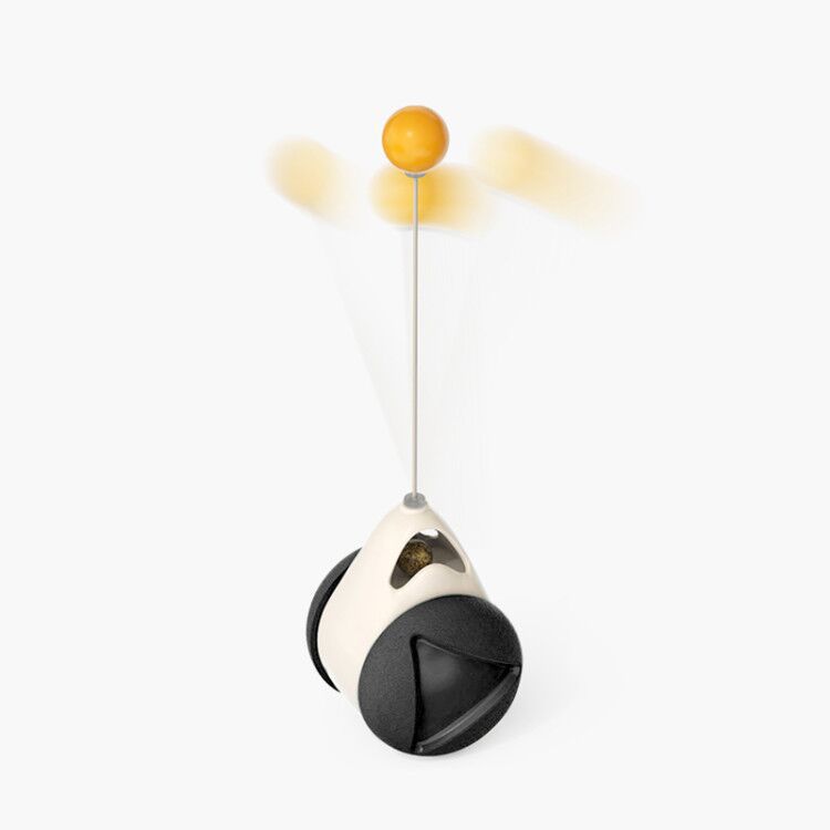 Toy with a yellow ball on a string against a white background
