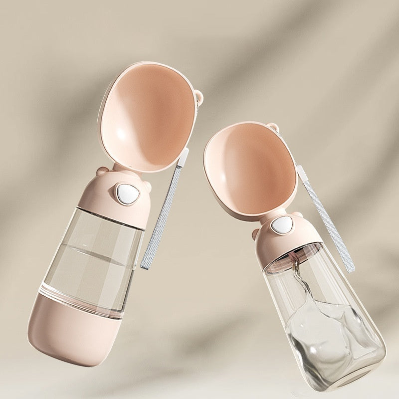 Two pink pet water bottles with clear interiors on a beige background
