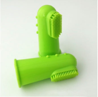 Green silicone cleaning brush on a white background