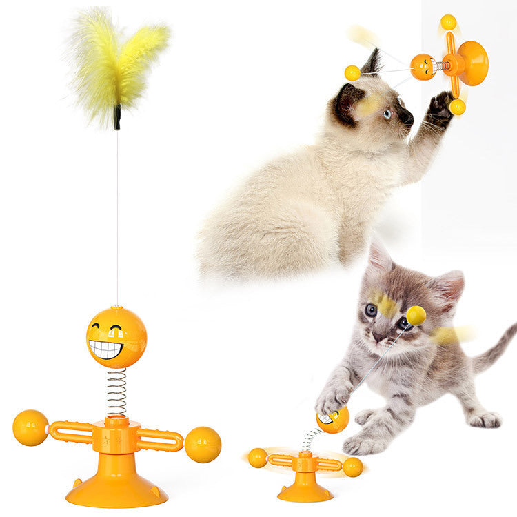 Cat playing with a yellow toy designed like a smiley face with a spring mechanism.
